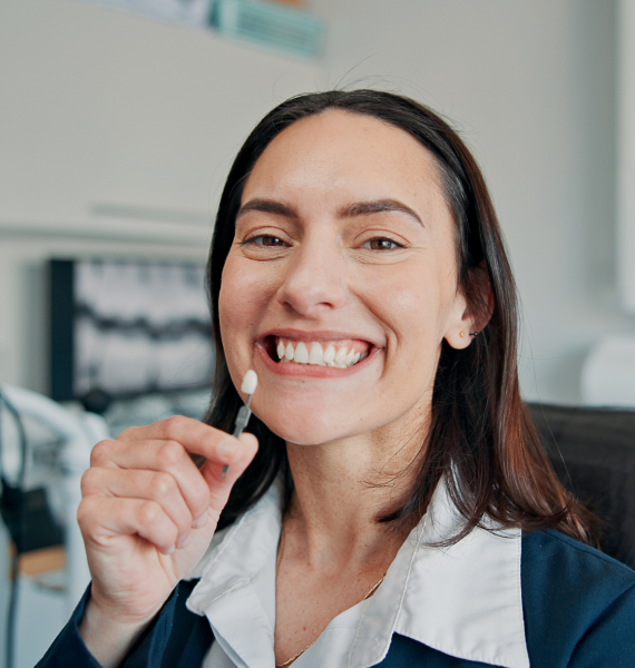 Smiling woman outside with healthy teeth